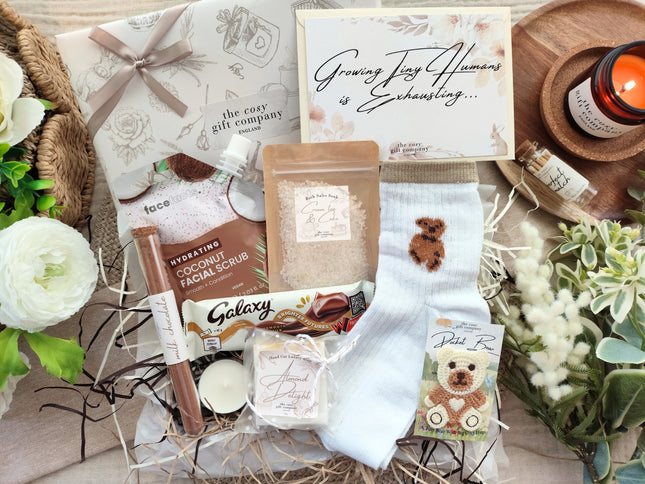 Gift Wrapped Box with various items including a bath salts, soap, and face scrub on a decorative surface with flowers.